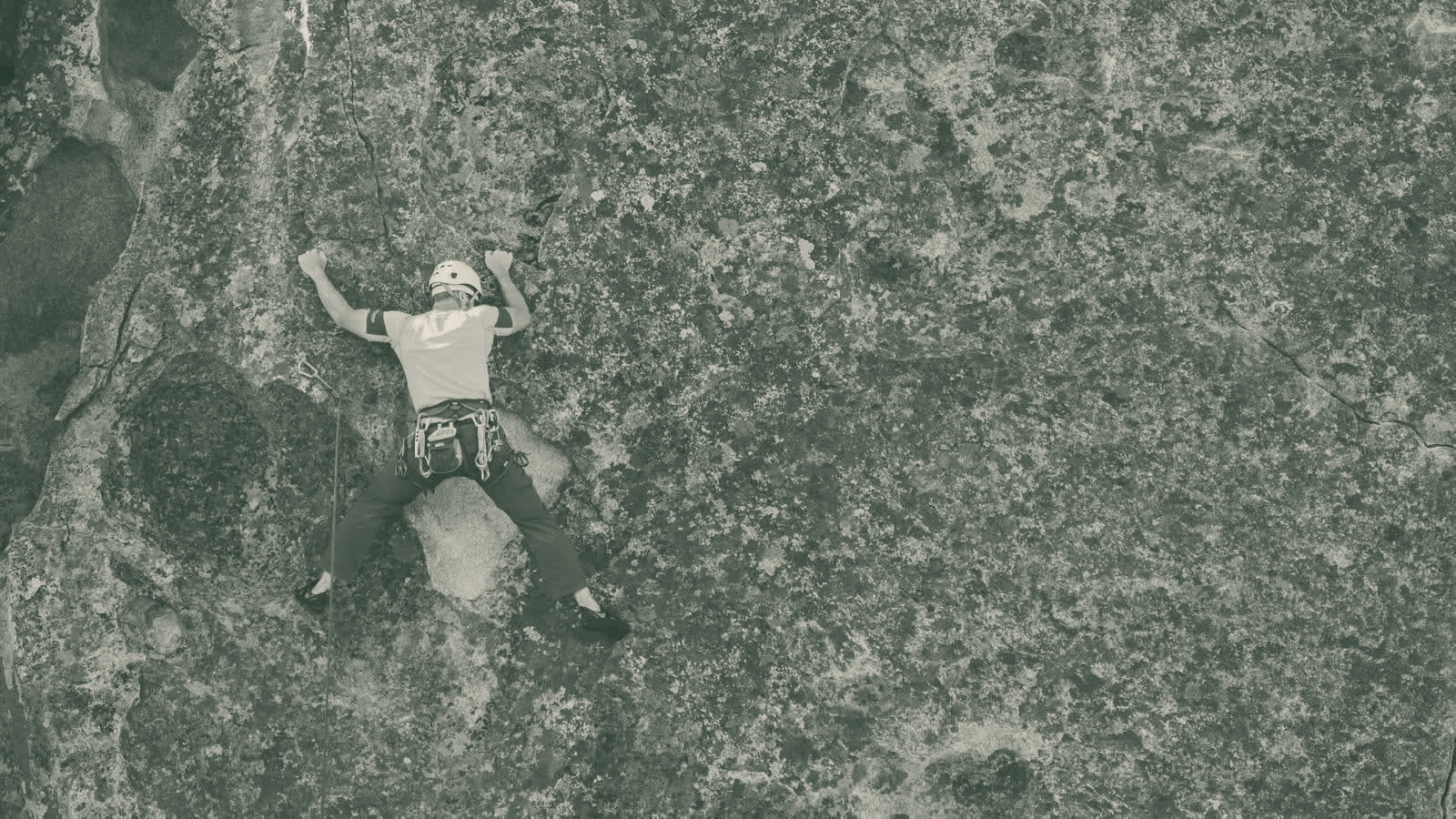A climber on a sandstone boulder