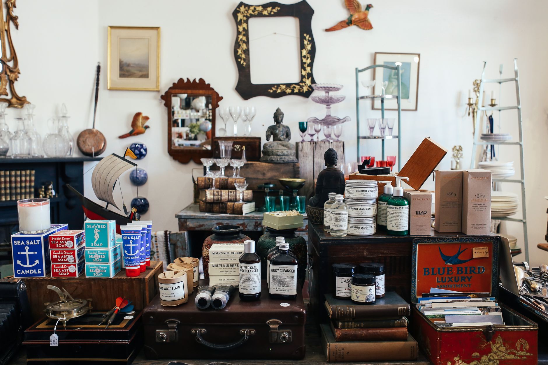 Vintage-style store display featuring eclectic decor and cosmetics.