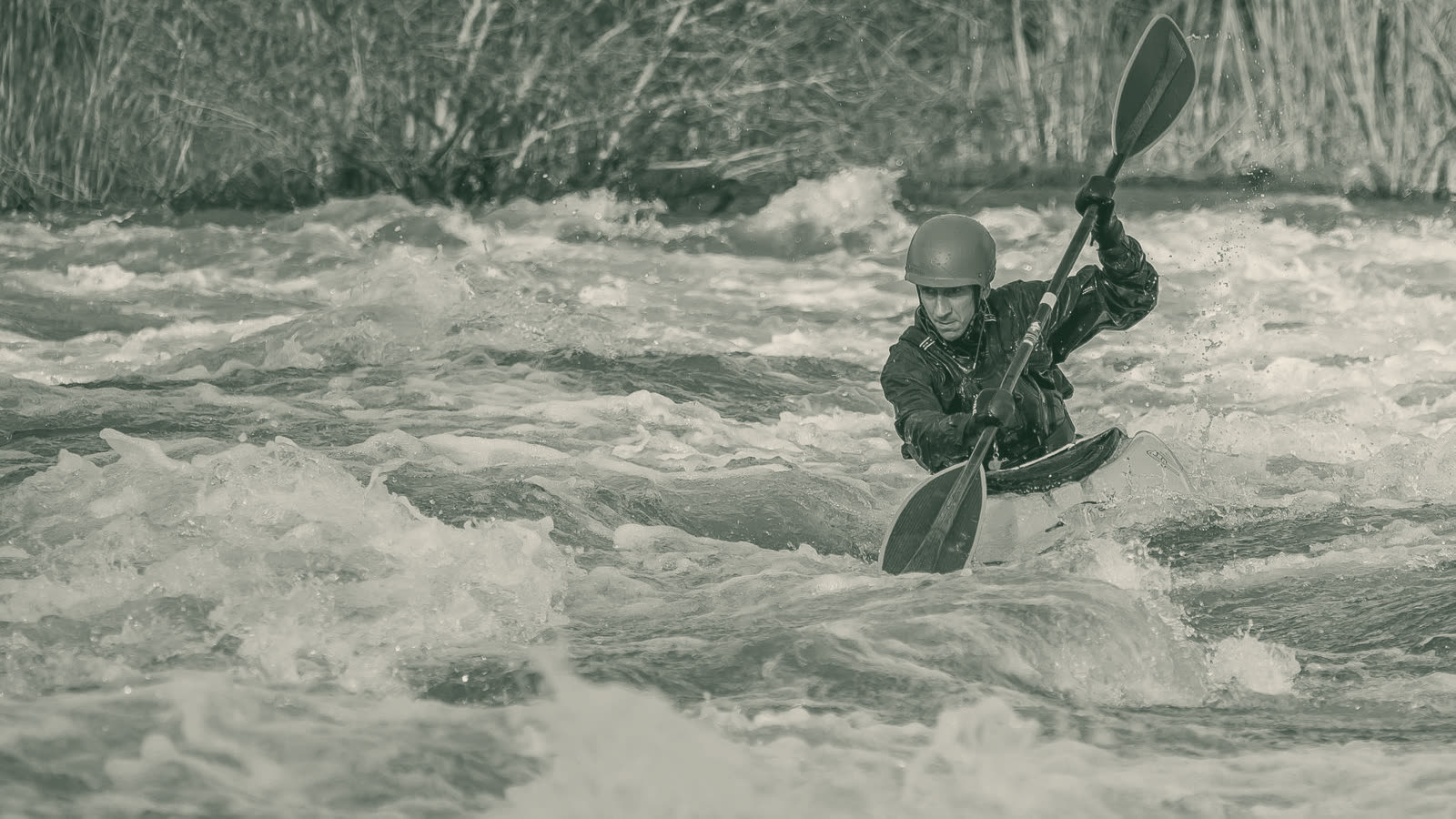 A kayaker paddling whitewater