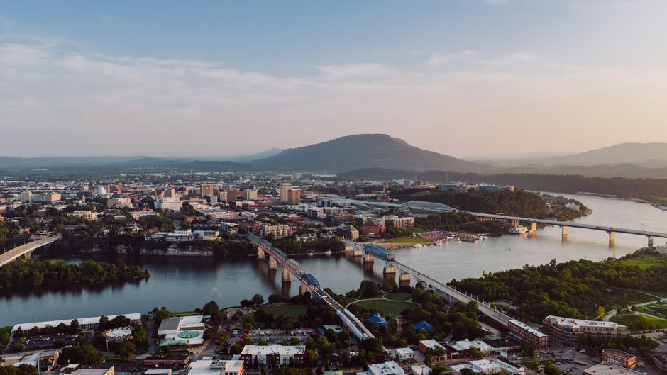 Breathtaking aerial view of Chattanooga, Tennessee skyline with iconic bridges and river at sunset.